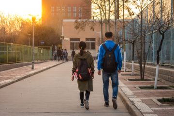 Two students Walking Side by Side on University Campus in Xi'an, China