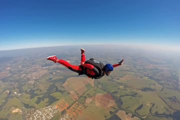 Falling skydiver opening parachute