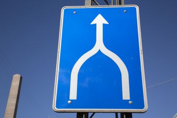 Road sign showing two roads converging into one