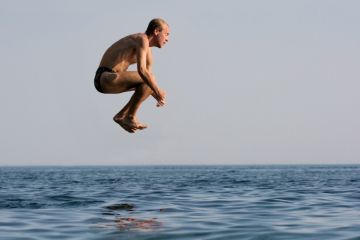 Man jumping into water Man jumping into water