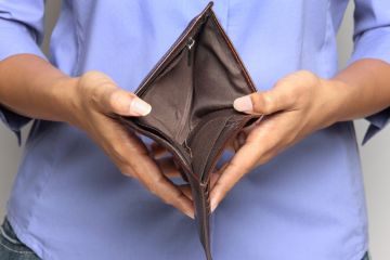 Person holding an empty wallet
