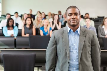 Black academic in lecture theatre Black academic in lecture theatre