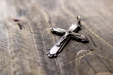 Christian cross on table