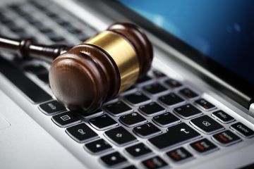 Judge's gavel on computer keyboard