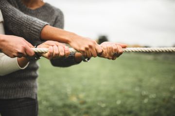 Two people taking part in a tug of war Two people taking part in a tug of war