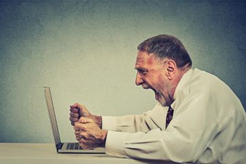 Angry man shouting at computer