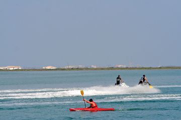 Kayaker and jet skiiers