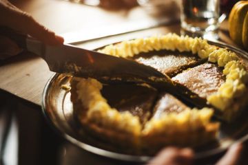 Knife cutting pie into slices