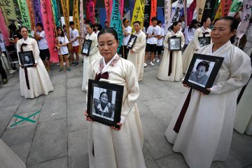 Protesters carry portraits of Korean women who were made sex slaves during Second World War Protesters carry portraits of Korean women who were made sex slaves during Second World War