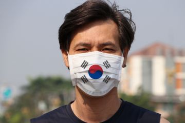 Man wearing a mask with the South Korean flag Man wearing a mask with the South Korean flag