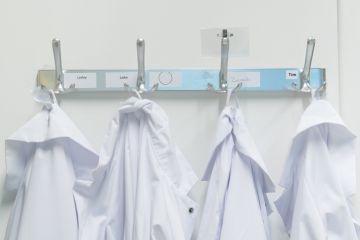 Lab coats on pegs Lab coats on pegs