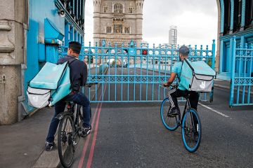 Deliveroo riders wait for Tower Bridge to open Deliveroo riders wait for Tower Bridge to open