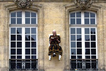 Woman sitting on wall