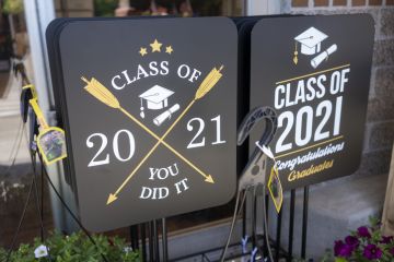 Lake Oswego, OR, USA - May 16, 2021 Graduation yard signs are seen for sale in a supermarket in Lake Oswego, Oregon.