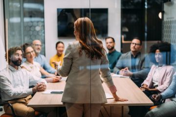 A woman gives a seminar, illustrating leadership