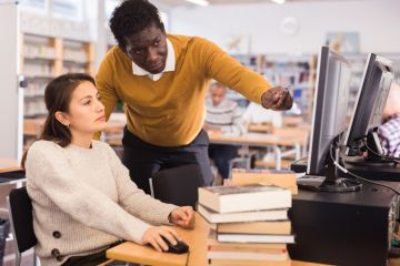 A librarian helping a student