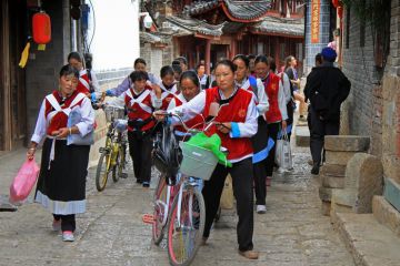 Women in the same clothes on the street in Lijiang, China, June 2015, illustrating repetition in postgraduate education in China