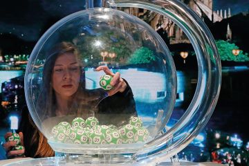 Woman drawing a lottery with cathedral in the background, research grants