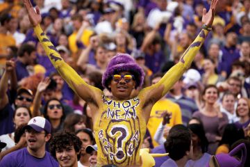 Louisiana State University student celebrating at American football game Louisiana State University student celebrating at American football game