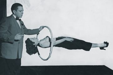 Magician performing gravity-defying trick