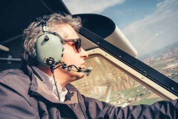 Male amateur pilot flying light aircraft
