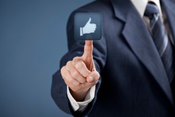 Man in suit pressing 'Like' button on touchscreen Man in suit pressing 'Like' button on touchscreen