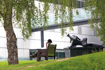 Man reading on bench, University of East Anglia