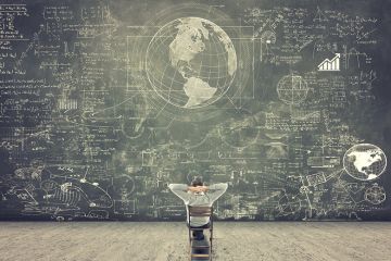 Man sitting on chair looking at blackboard full of scientific figures and graphs Man sitting on chair looking at blackboard full of scientific figures and graphs