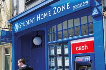 Man walking past Student Home Zone office Man walking past Student Home Zone office