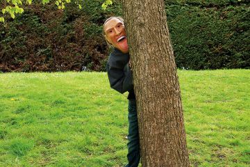 Man wearing mask behind tree Man wearing mask behind tree