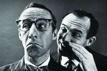 Man whispering in other man's ear Man whispering in other man's ear