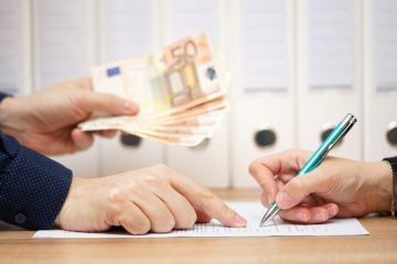 Man holding euros forcing woman to sign