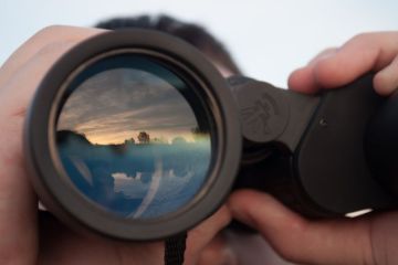 Man looking through binoculars