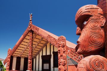 Maori wood carving outside of Te Papaiouru Marae, a Maori meeting house in the tourist town of Rotorua, New Zealand Maori wood carving outside of Te Papaiouru Marae, a Maori meeting house in the tourist town of Rotorua, New Zealand