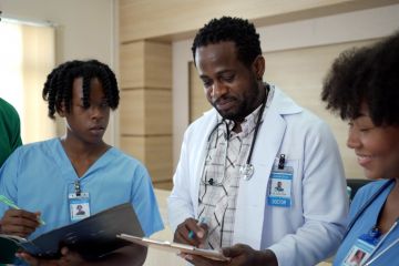 A Black doctor teaches two Black students