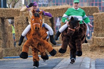 Men competing in pantomime horse race, Birmingham Men competing in pantomime horse race, Birmingham