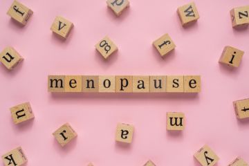 Scrabble tiles reading "menopause" Scrabble tiles reading "menopause"