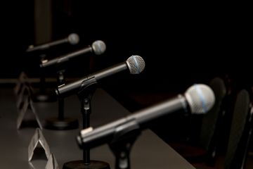 A row of microphones, symbolising debate A row of microphones, symbolising debate