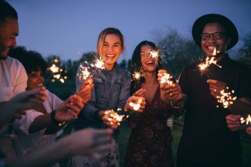 A group of millennials with sparklers A group of millennials with sparklers