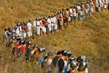 Miners standing in a line in a field