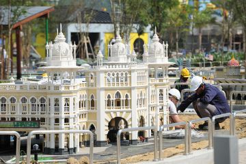 Construction workers work near a miniature of Kuala Lumpur's railway station. To illustrate how universities in Asia are responding to the fast growth of cities. Construction workers work near a miniature of Kuala Lumpur's railway station. To illustrate how universities in Asia are responding to the fast growth of cities.