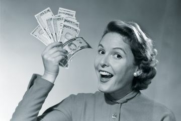 Woman holds up money