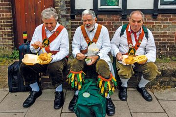 Morris dancers eat fish and chips