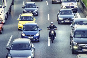 A motorbike slips through a traffic jam, symbolising rapid completion of a PhD A motorbike slips through a traffic jam, symbolising rapid completion of a PhD