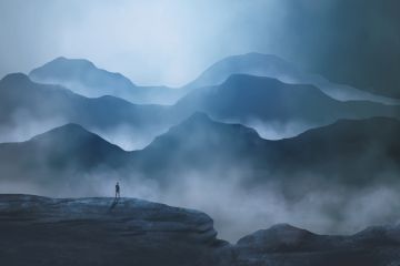 A man faced by enormous mountains A man faced by enormous mountains