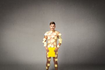 A naked man covered in post-it notes A naked man covered in post-it notes, symbolising public speaking