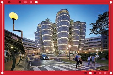 Campus with marked pedestrian crossing and illuminated Learning Hub. NTU - Nanyang Technological University, Singapore