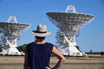 Narrabri, Nsw- MAR 03 2023Australian woman looking at the Telescope Compact Array near Narrabri NSW, that observe star formation, the late stages of stars lives, supernovae and magnetic fields.