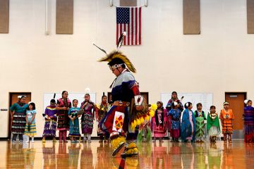 A student performs a traditional style dance in full regalia at the 21st Century Community Learning Center, USA. Students that are part of the after school learning program learn the Arapaho language, culture, history and traditions of the Arapaho tribe.