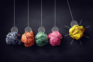 A Newton's cradle with crumpled paper lightbulbs A Newton's cradle with crumpled paper lightbulbs, one of which is lit, symbolising ideas for efficiency